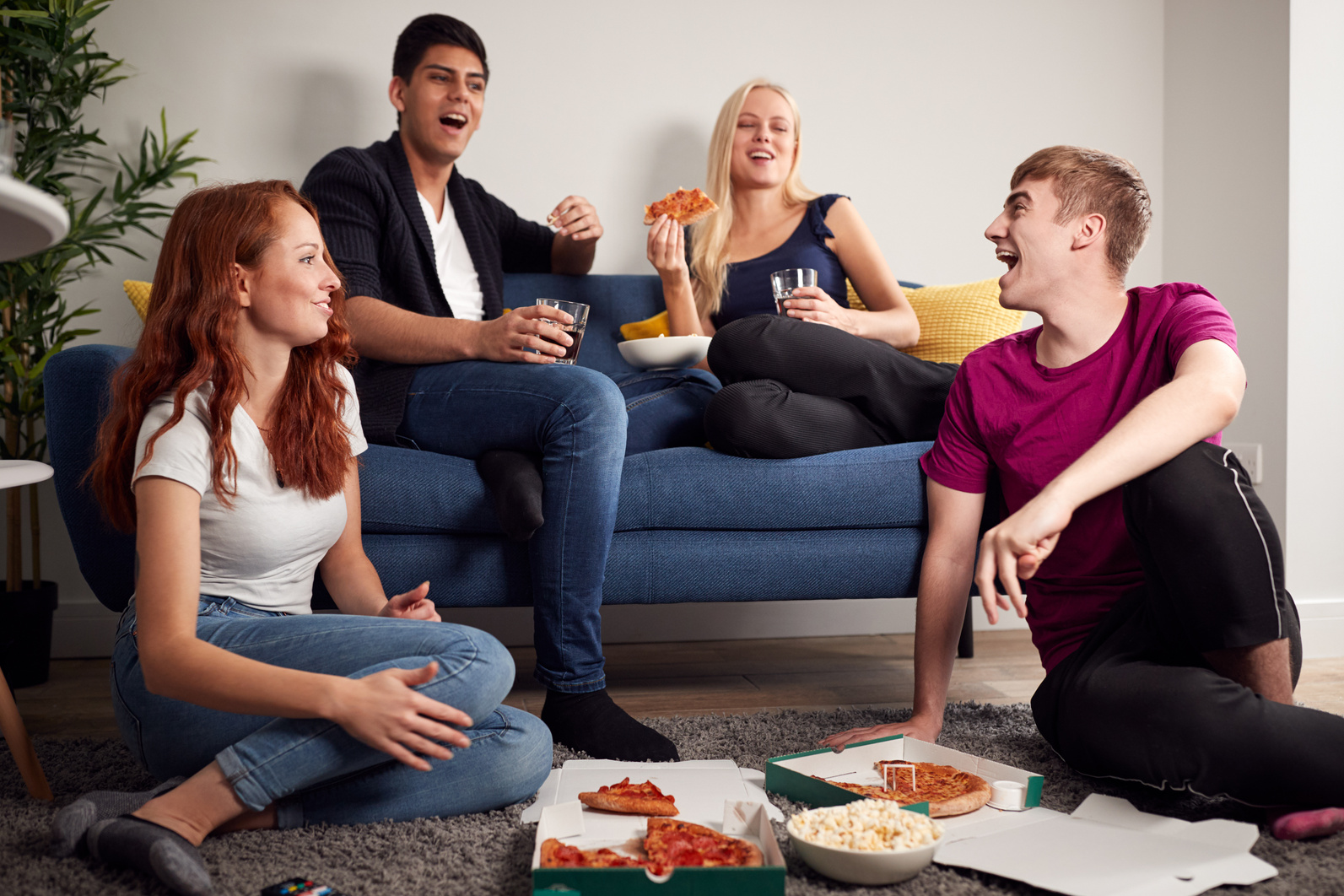 Group of College Students in Shared House Having Night in Eating